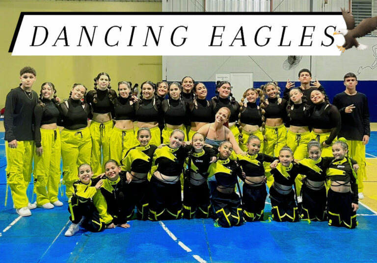 Dancing Eagles dance team in neon yellow and black outfits posing in gymnasium