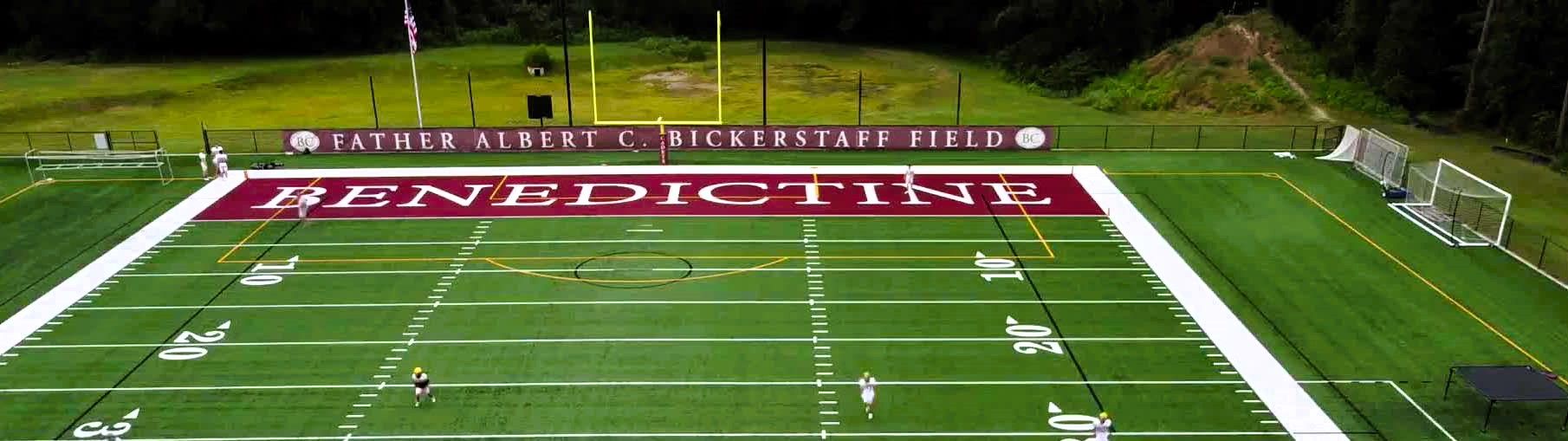 Aerial view of Father Albert C. Bickerstaff Field synthetic turf football stadium with maroon end zone