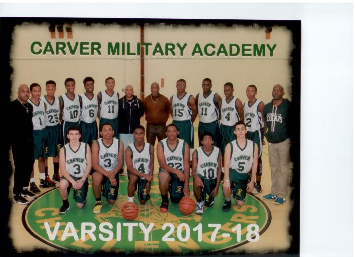 2017-18 varsity basketball team in green and white Carver jerseys with coaches in gymnasium