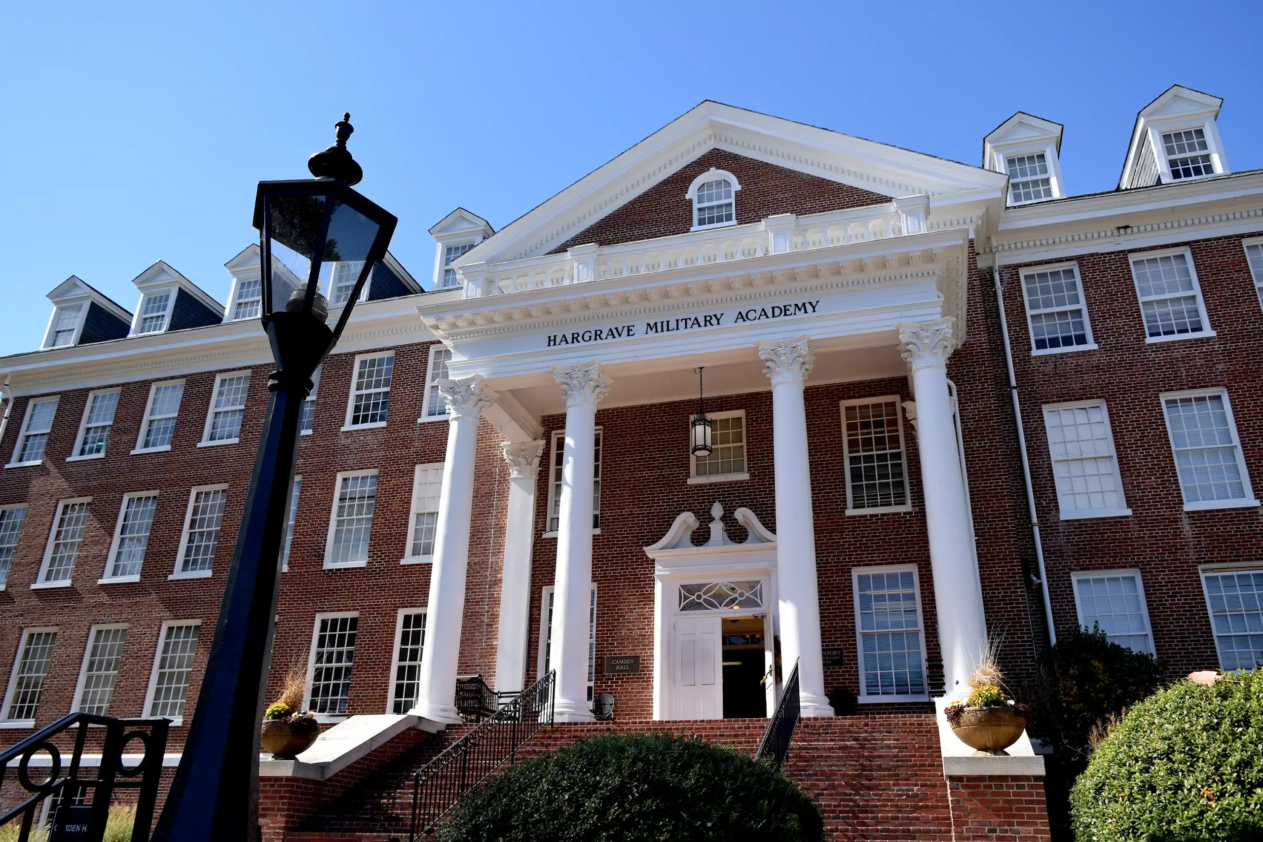 Front view of main hall with white columns and Hargrave Military Academy signage on pediment