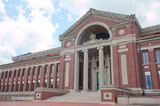 Front entrance of Roosevelt Hall showing columned portico, eagle emblem, and grand stone staircase