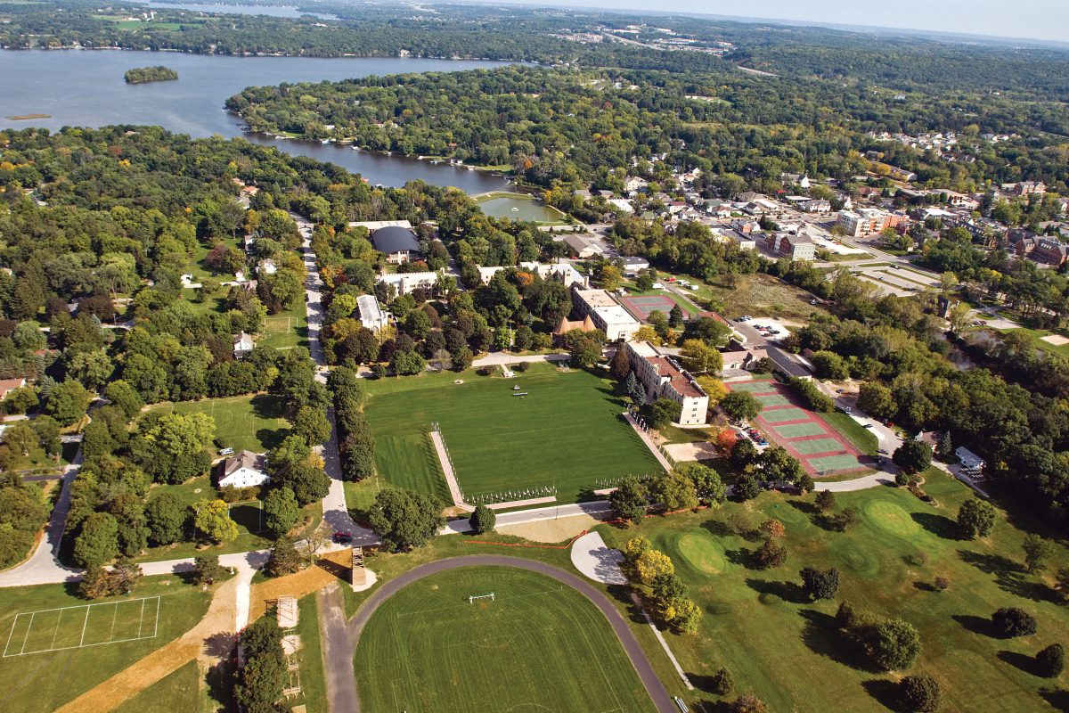 Aerial view of 150-acre campus showing athletic fields, track, tennis courts, and Nagawicka Lake shoreline