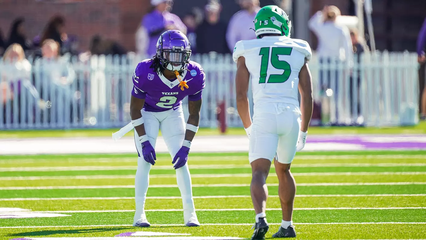 Texans football player number 2 in purple jersey in defensive stance facing opponent on game day